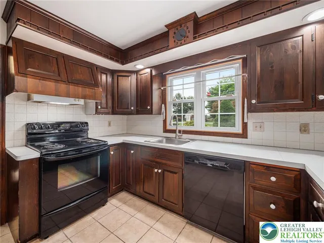 a kitchen with stainless steel appliances a sink and a refrigerator