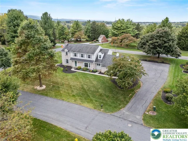 a aerial view of a house with a yard basket ball court and outdoor seating