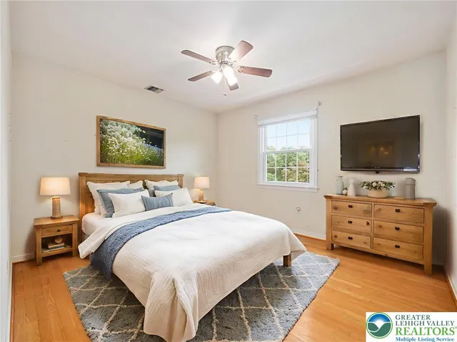 a view of a house with a big yard and large tree
