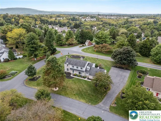 an aerial view of a house with a yard