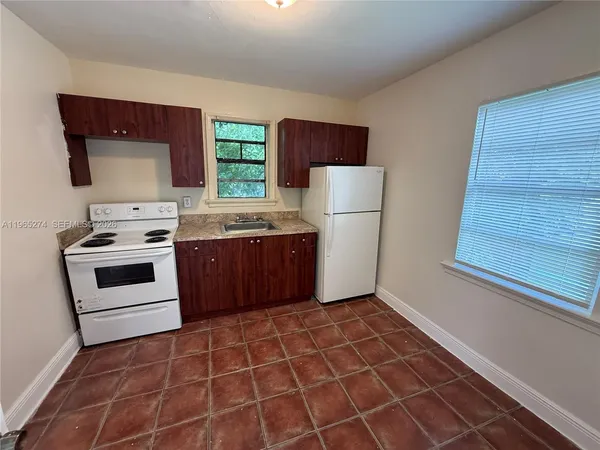 a kitchen with a stove a sink and a refrigerator