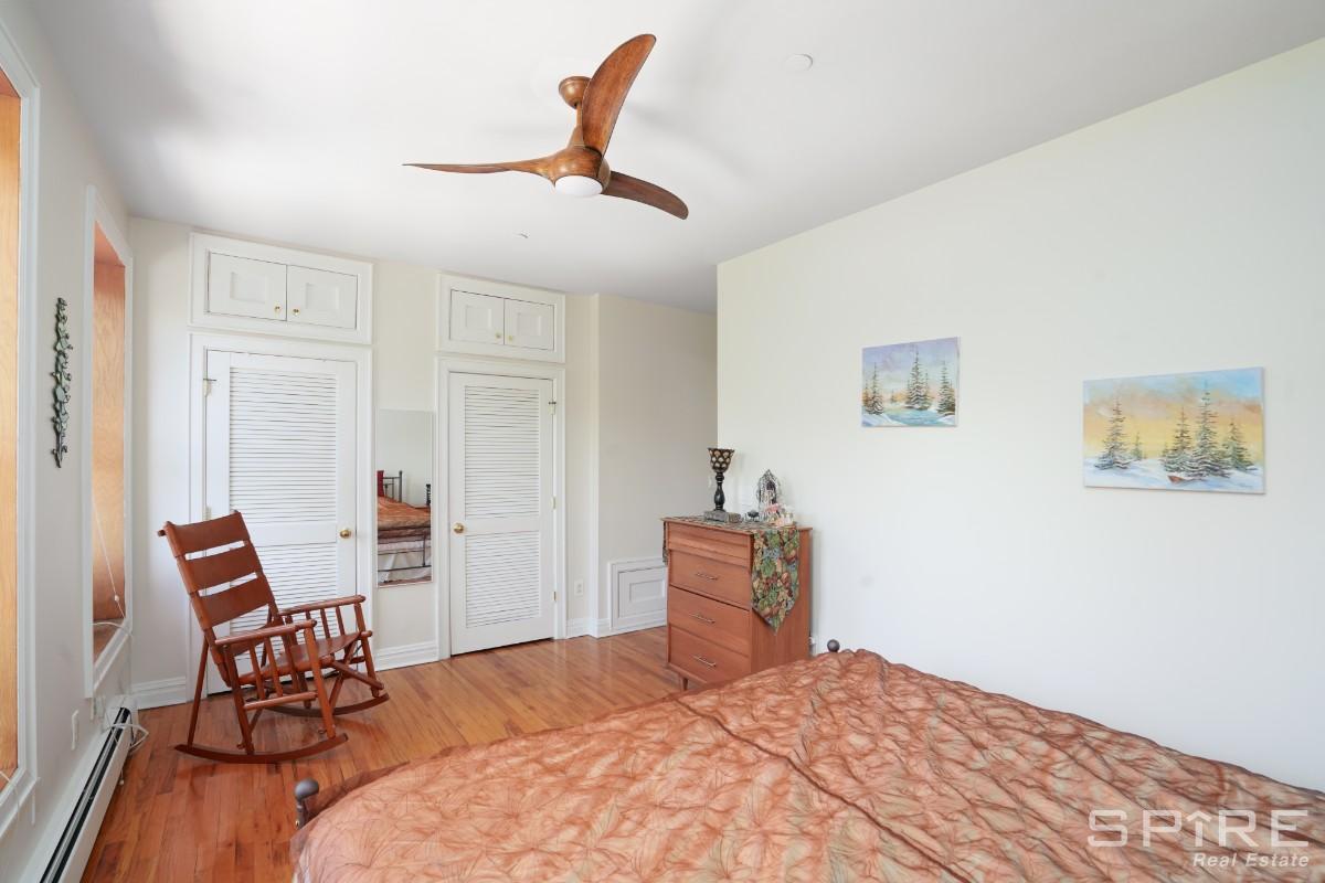 370 St Nicholas Avenue, Unit 5B Manhattan, NY 10027 - Photo 13 of 23 a bedroom with a bed and a chair