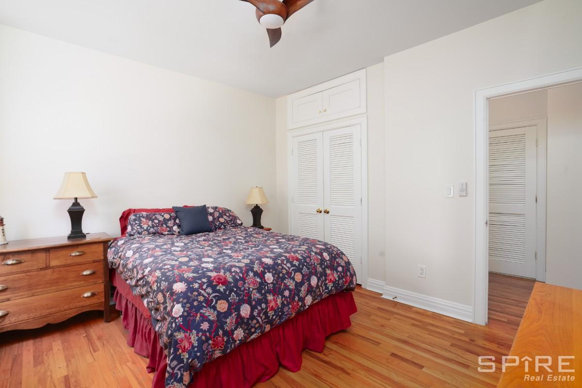 370 St Nicholas Avenue, Unit 5B Manhattan, NY 10027 - Photo 15 of 23 a bedroom with a bed and wooden floor