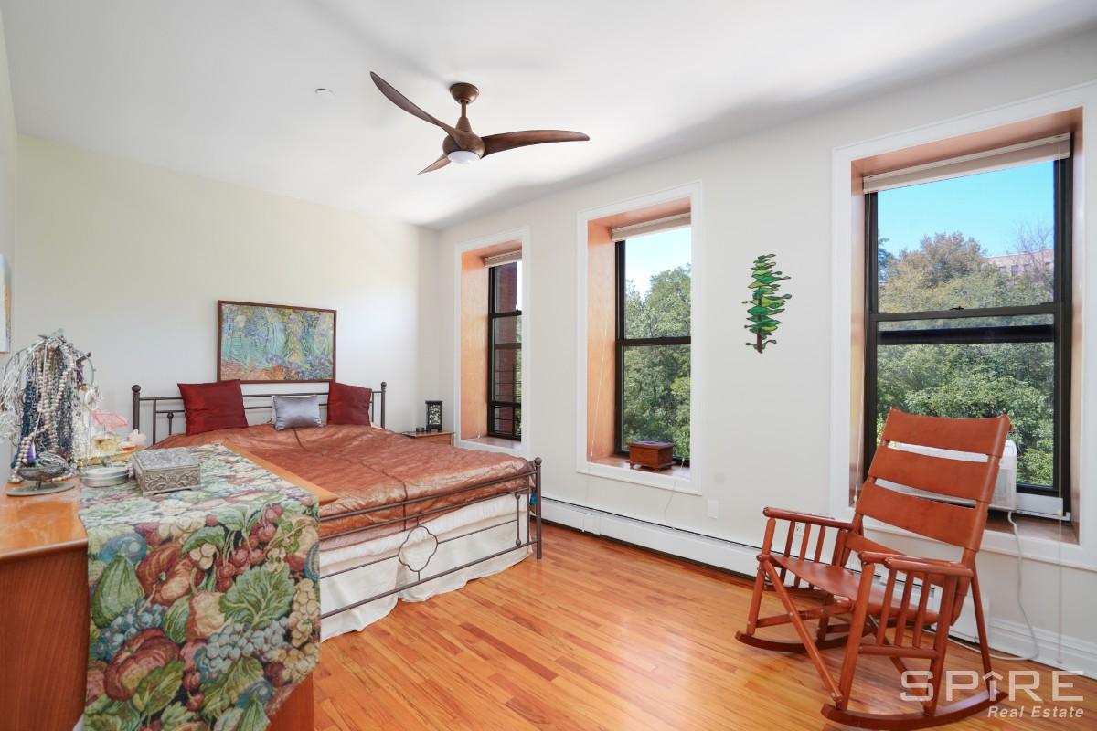 370 St Nicholas Avenue, Unit 5B Manhattan, NY 10027 - Photo 10 of 23 a bedroom with a bed a window and chair