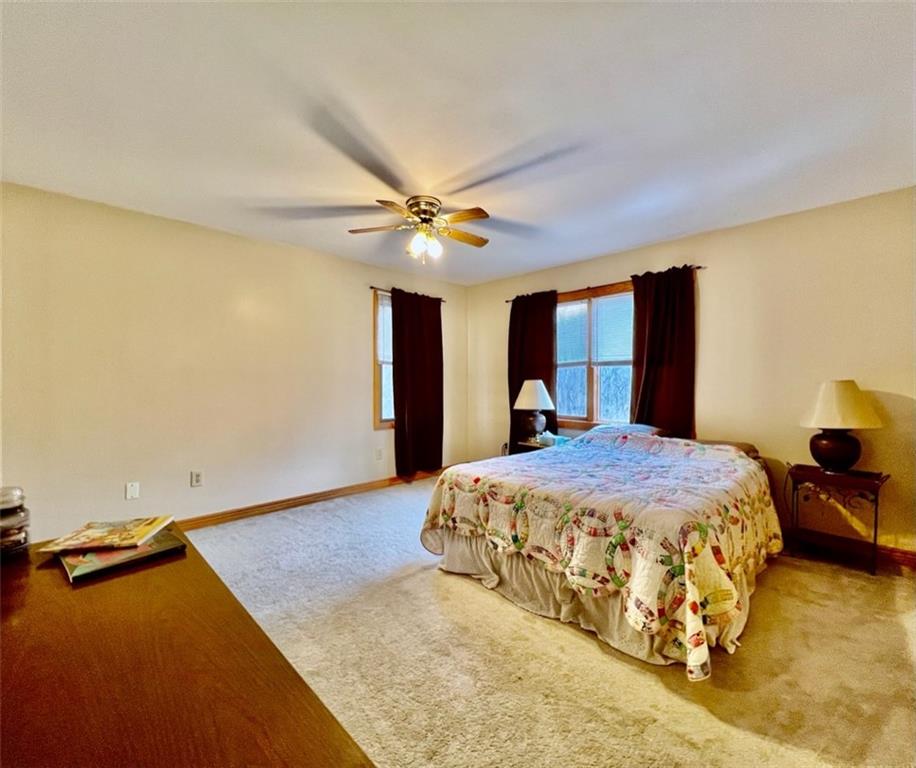 84 Mc Ewen Road Mercer, PA 16137 - Photo 15 of 18 a bedroom with a bed and a chandelier