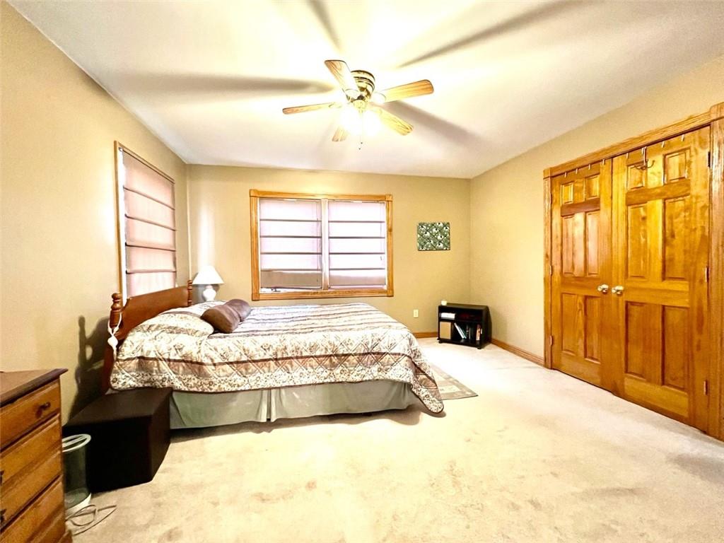 84 Mc Ewen Road Mercer, PA 16137 - Photo 8 of 18 a spacious bedroom with a bed and dresser with wooden floor