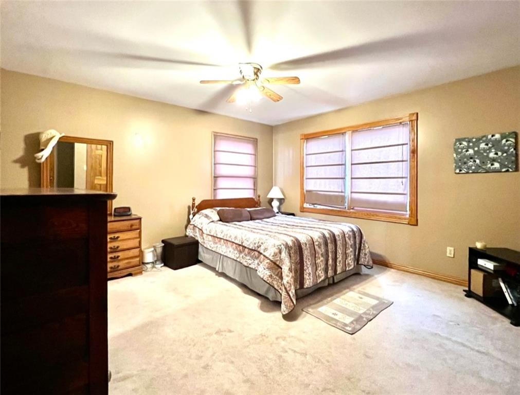 84 Mc Ewen Road Mercer, PA 16137 - Photo 9 of 18 a bedroom with a bed and wooden floor