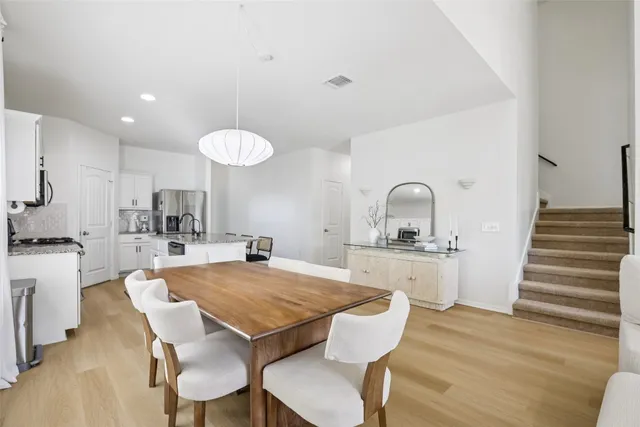 a large kitchen with a table and chairs