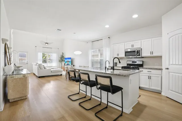 a kitchen with sink cabinets and dining table