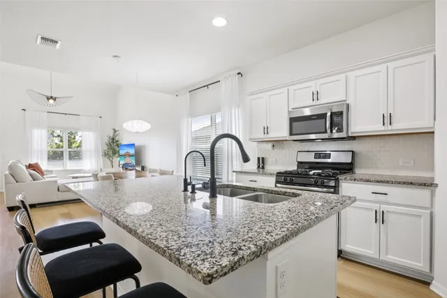 a kitchen with sink cabinets and wooden floor