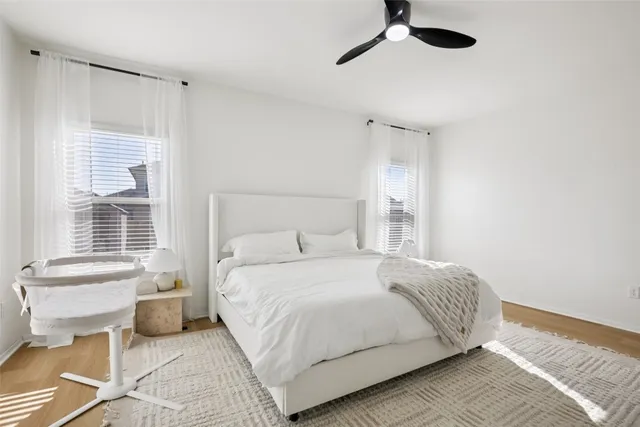 a bedroom with a bed and a window