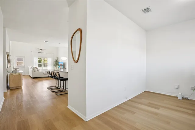 a living room with furniture and a large mirror