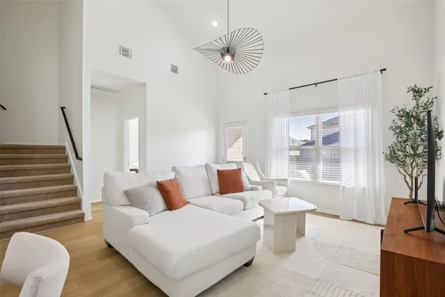 a view of living room and kitchen with wooden floor