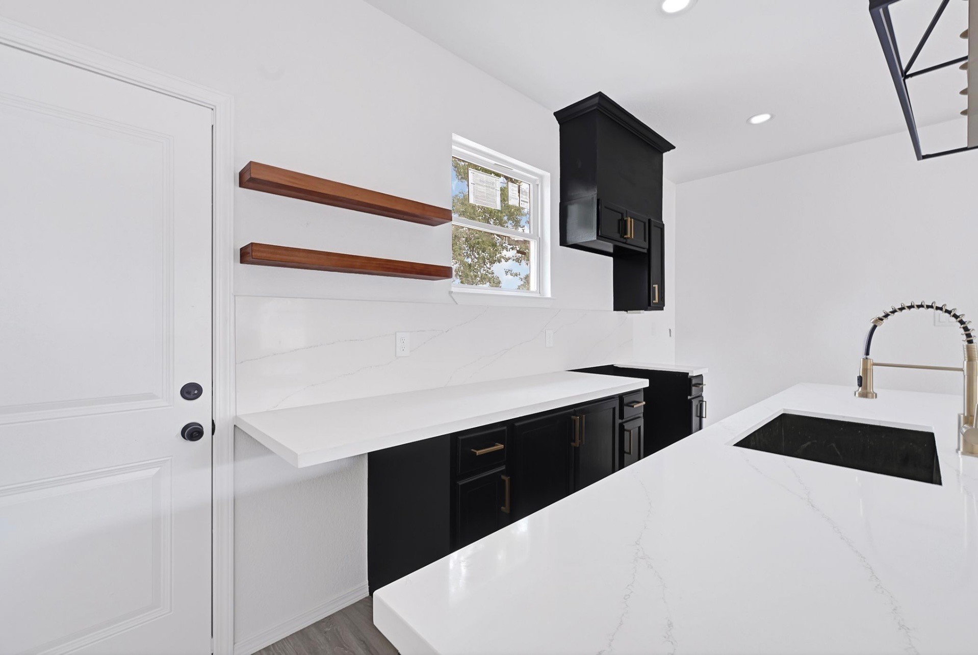 7939 Goode Street Houston, TX 77012 - Photo 6 of 14 a kitchen with a sink dishwasher and wooden cabinets