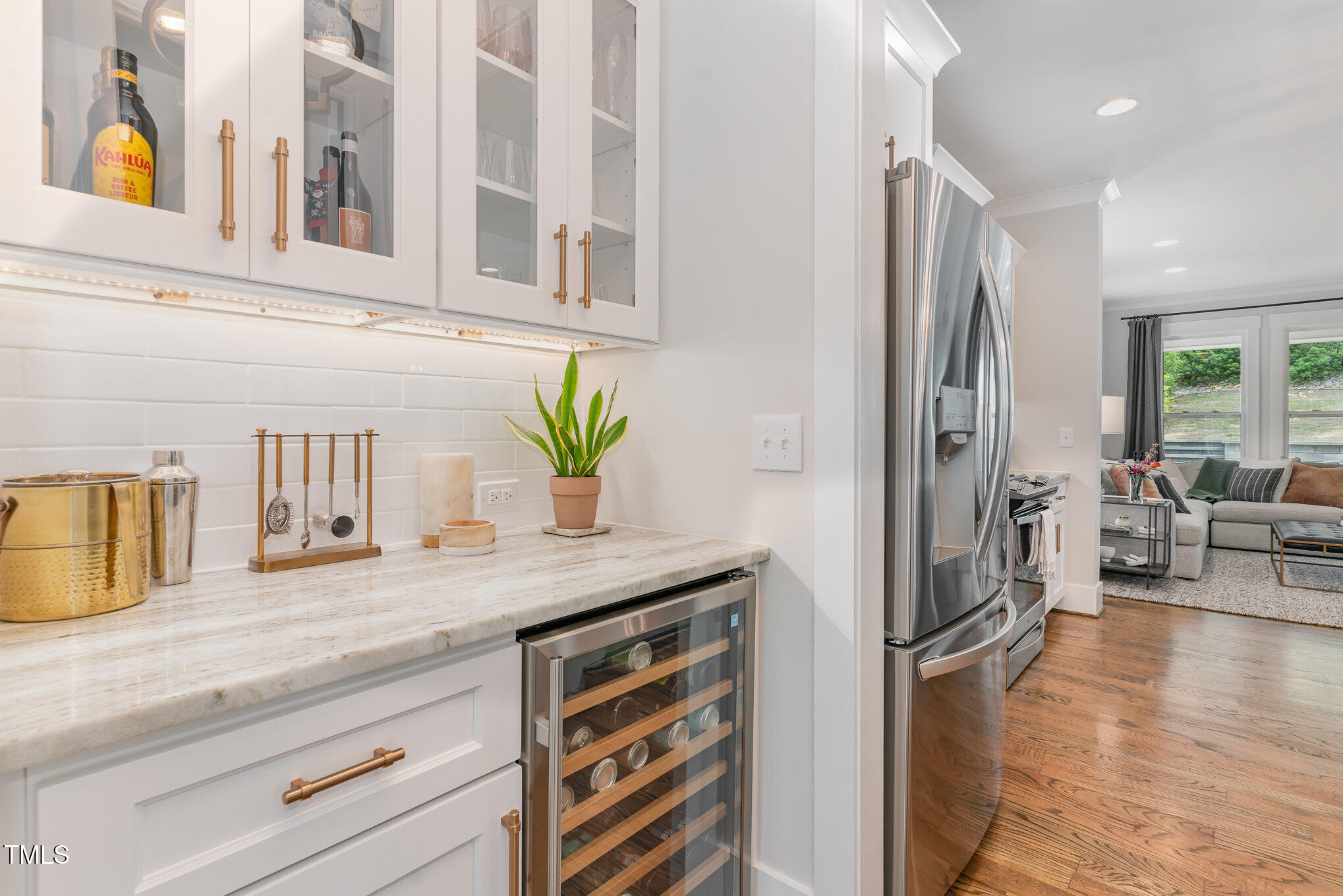 1422 Banbury Road Raleigh, NC 27607 - Photo 14 of 48 a kitchen with stainless steel appliances granite countertop a refrigerator a oven a dining table and chairs with wooden floor