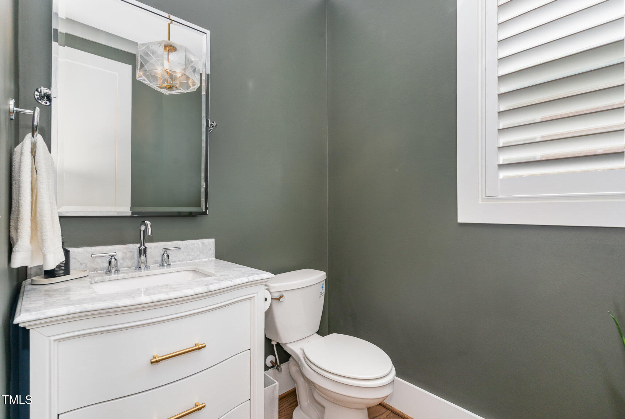 1422 Banbury Road Raleigh, NC 27607 - Photo 16 of 48 a bathroom with a granite countertop toilet sink and mirror