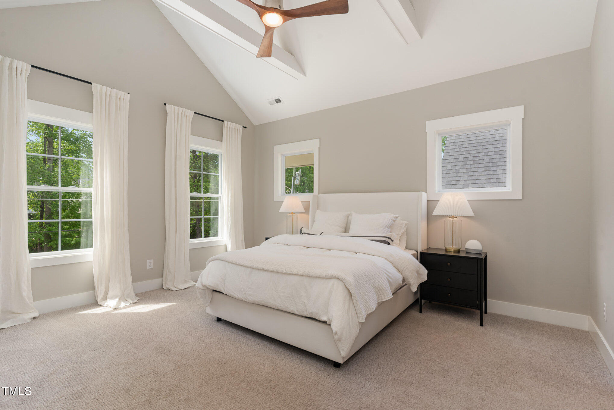 1422 Banbury Road Raleigh, NC 27607 - Photo 18 of 48 a bedroom with a bed lamp and window