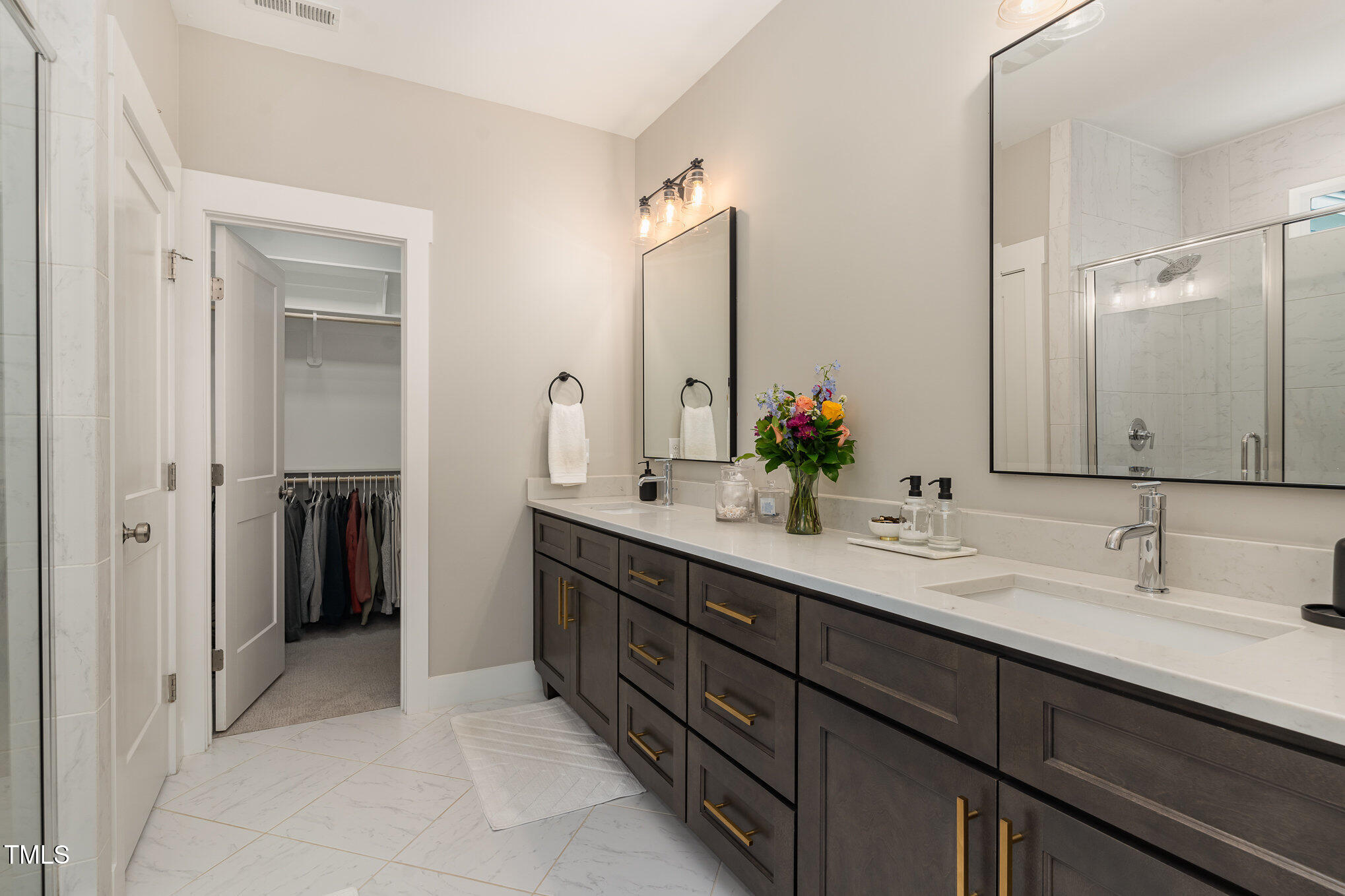 1422 Banbury Road Raleigh, NC 27607 - Photo 20 of 48 a bathroom with a double vanity sink and a mirror