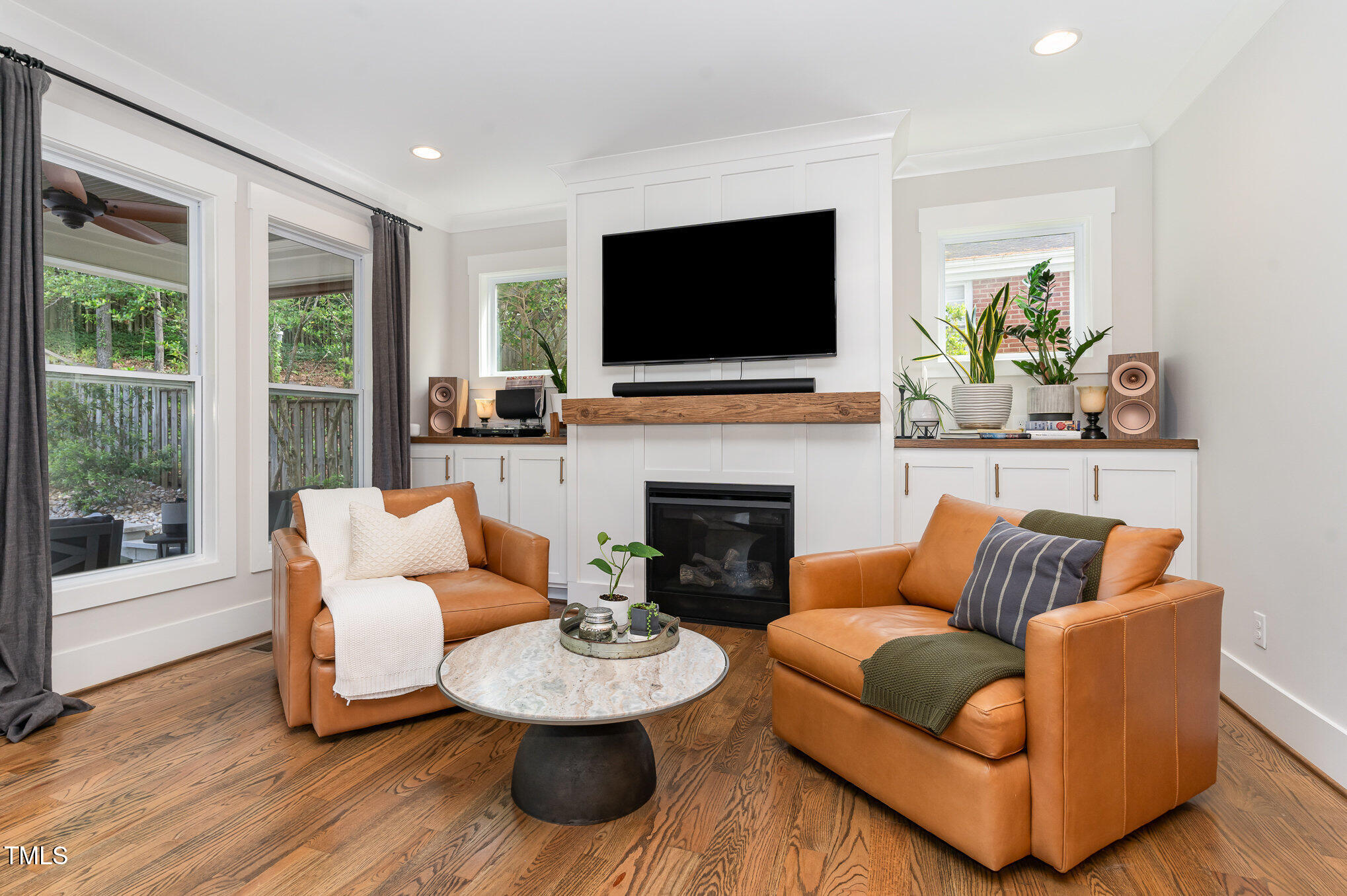 1422 Banbury Road Raleigh, NC 27607 - Photo 6 of 48 a living room with fireplace furniture and a flat screen tv