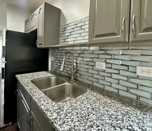 a kitchen with a sink and cabinets