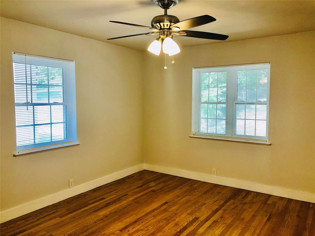 716 Kessler Boulevard Sherman, TX 75092 - Photo 15 of 27 Spare room with dark wood-style flooring and a ceiling fan