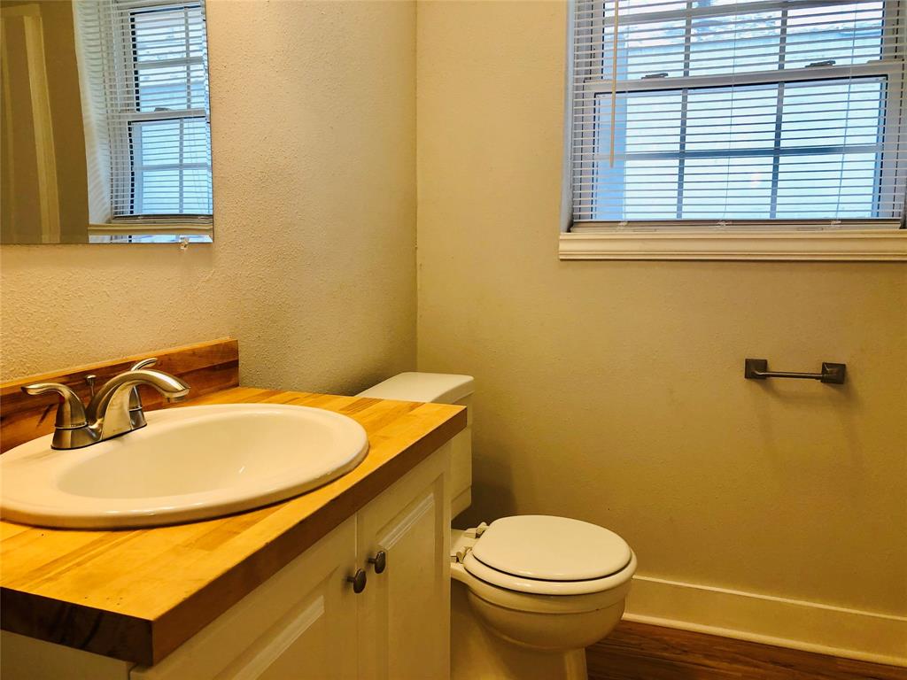 716 Kessler Boulevard Sherman, TX 75092 - Photo 16 of 27 Bathroom featuring vanity and wood finished floors