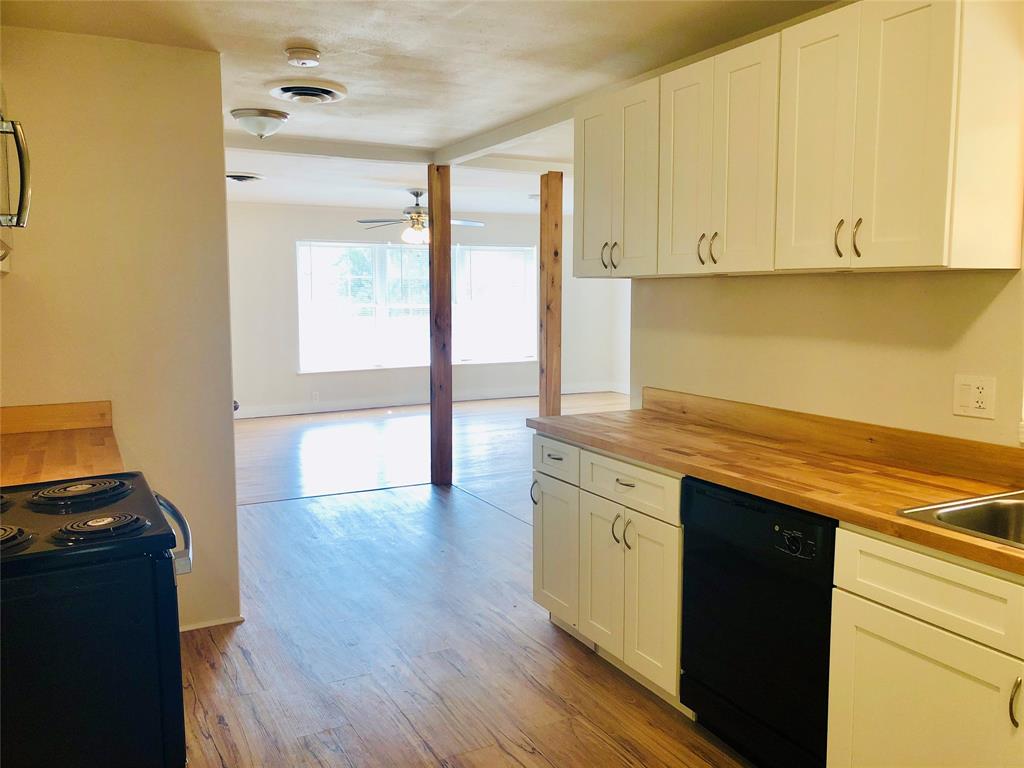 716 Kessler Boulevard Sherman, TX 75092 - Photo 6 of 27 Kitchen with butcher block counters, black appliances, light wood-type flooring, ceiling fan, and white cabinets