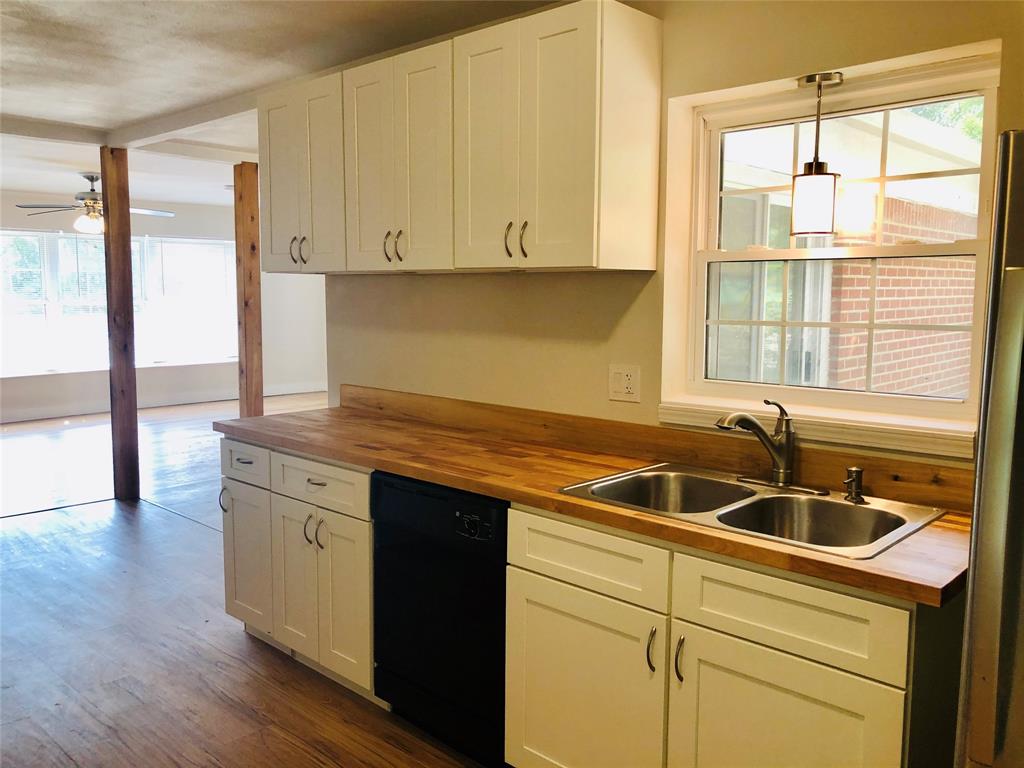 716 Kessler Boulevard Sherman, TX 75092 - Photo 10 of 27 Kitchen with butcher block countertops, dishwasher, a ceiling fan, and white cabinetry