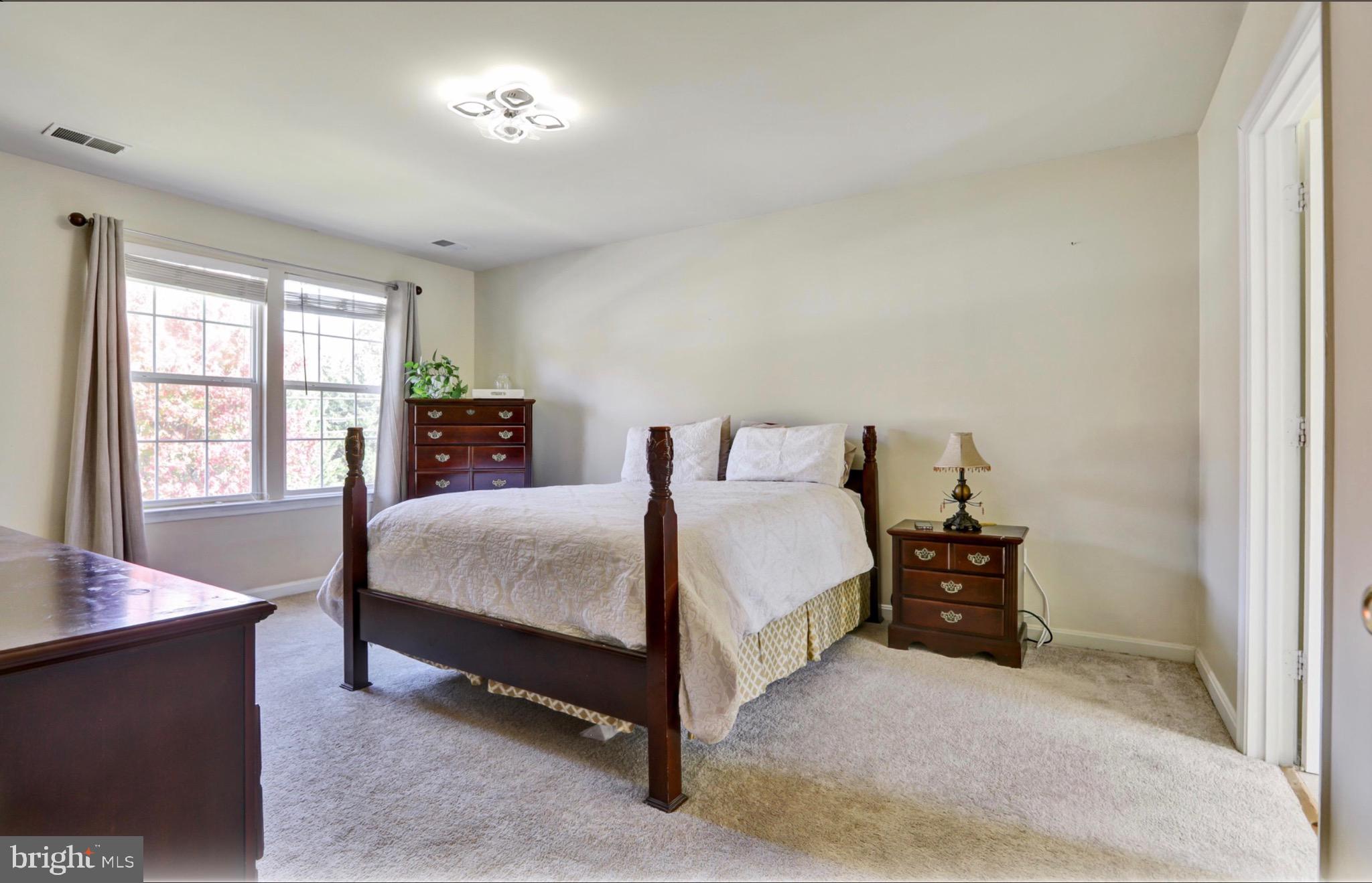 4305 Silver Spring Road Perry Hall, MD 21236 - Photo 13 of 29 a spacious bedroom with a bed and a large window