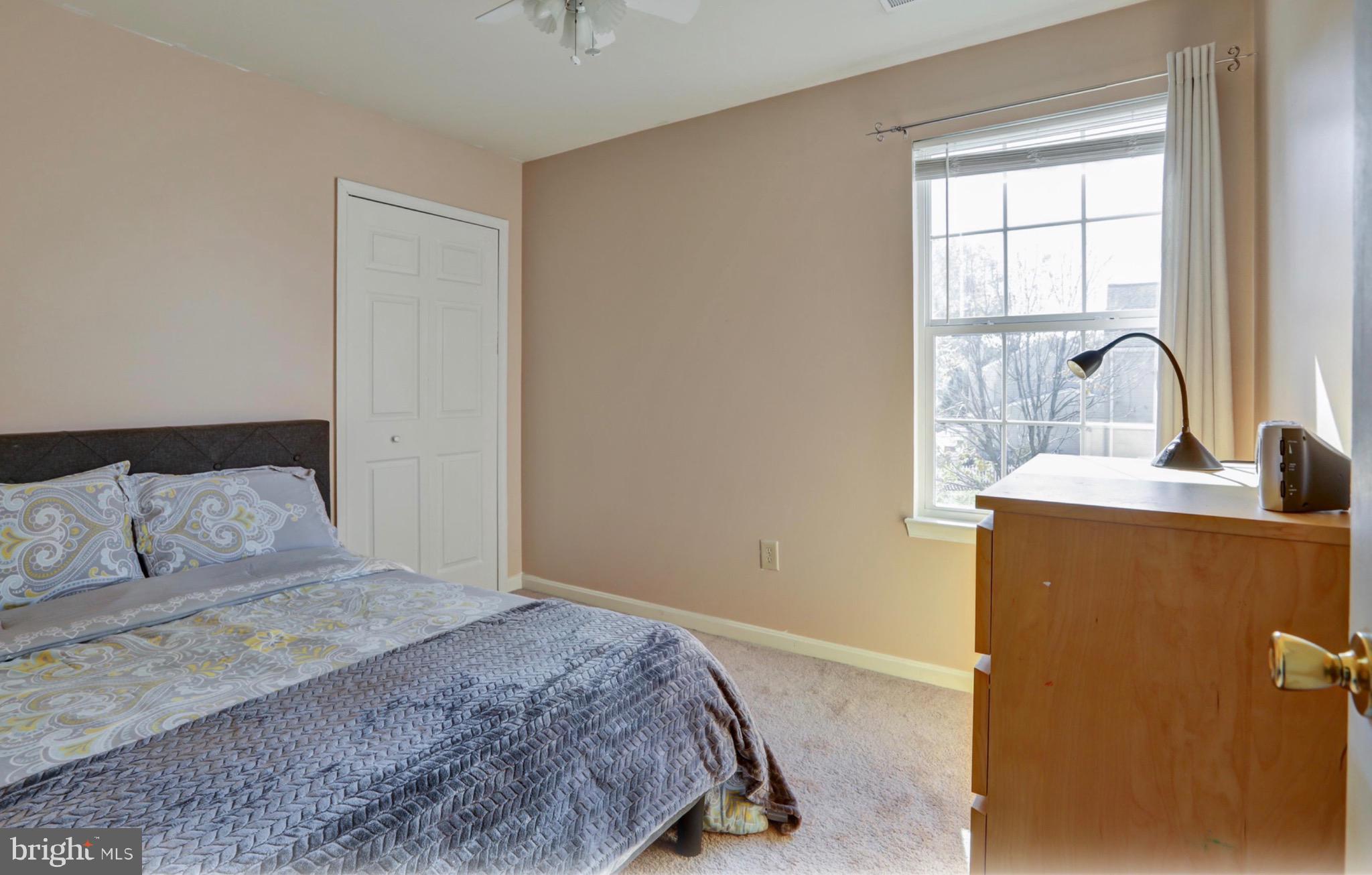 4305 Silver Spring Road Perry Hall, MD 21236 - Photo 16 of 29 a bedroom with a bed wooden floor and window