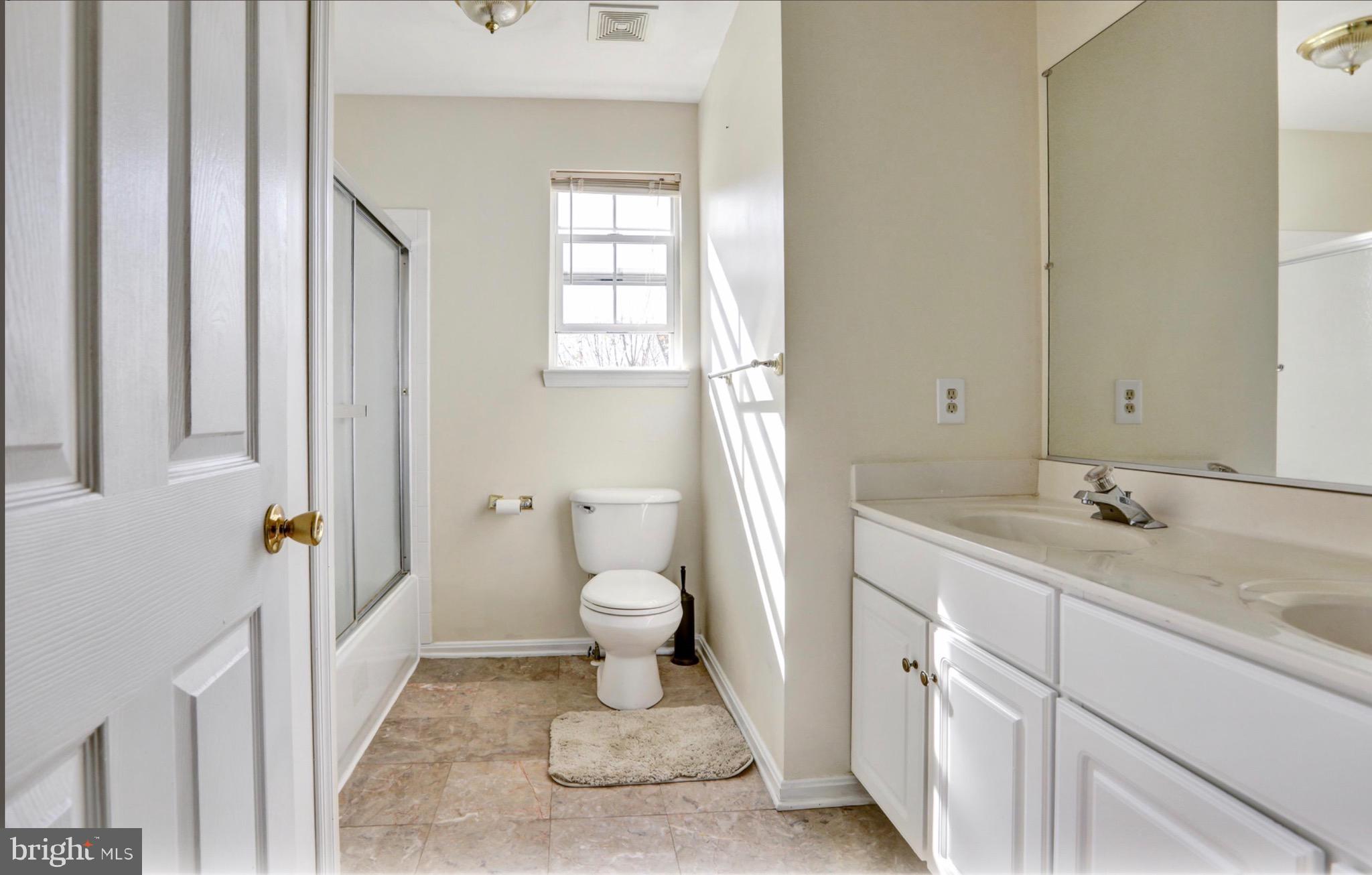 4305 Silver Spring Road Perry Hall, MD 21236 - Photo 17 of 29 a bathroom with a sink a toilet and a window
