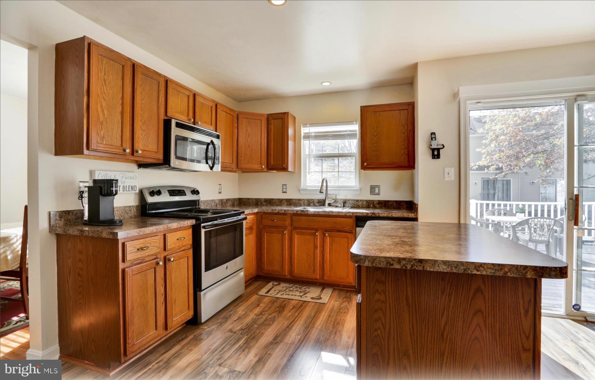4305 Silver Spring Road Perry Hall, MD 21236 - Photo 2 of 29 a kitchen with stainless steel appliances granite countertop a stove a sink and a microwave