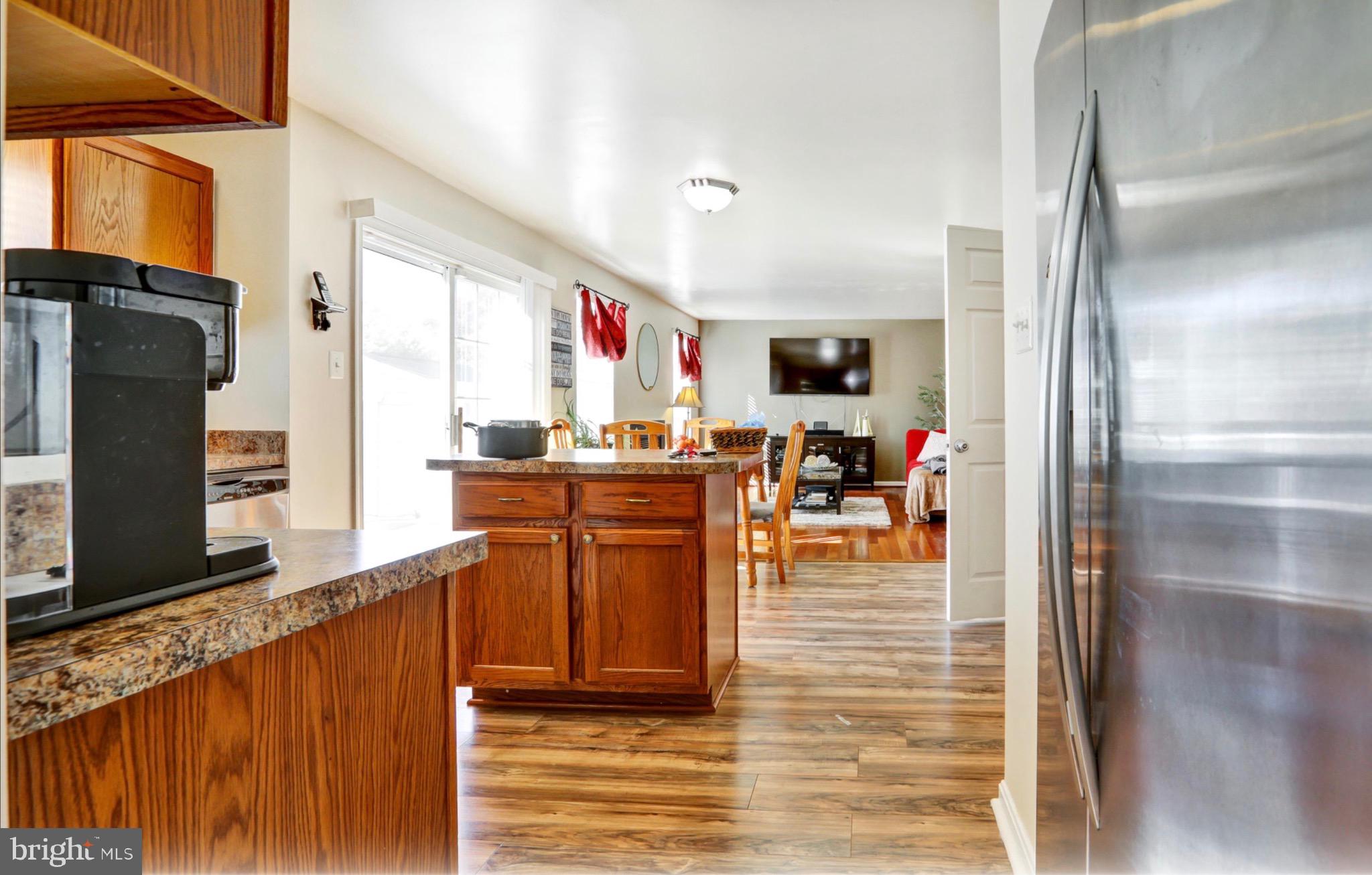 4305 Silver Spring Road Perry Hall, MD 21236 - Photo 3 of 29 a kitchen with stainless steel appliances granite countertop a refrigerator and a stove top oven