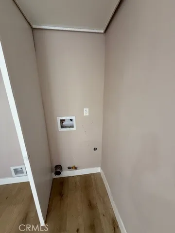 a view of a room with wooden floor and white walls