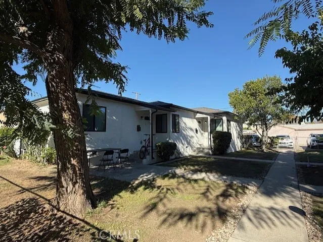 a view of a house with a yard covered with snow in the background