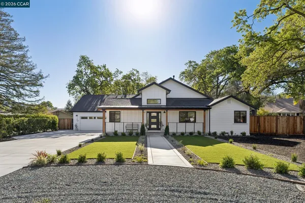 a view of house with swimming pool outdoor seating and house in the background