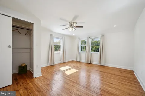 a spacious bedroom with a bed and glass door