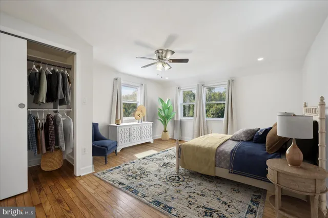 a view of empty room with wooden floor and window