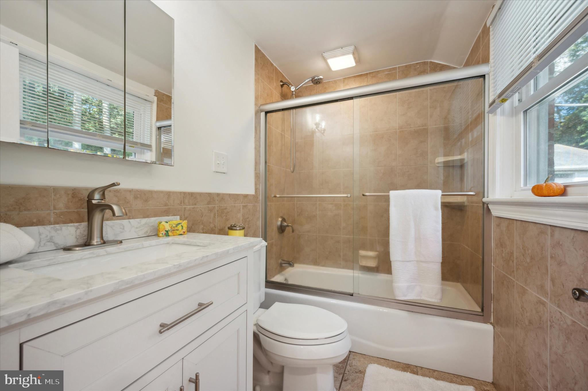 907 Powder Mill Lane Wynnewood, PA 19096 - Photo 21 of 31 a bathroom with a granite countertop sink toilet and shower