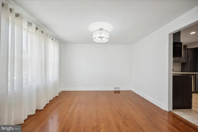 a view of a room with wooden floor and white walls