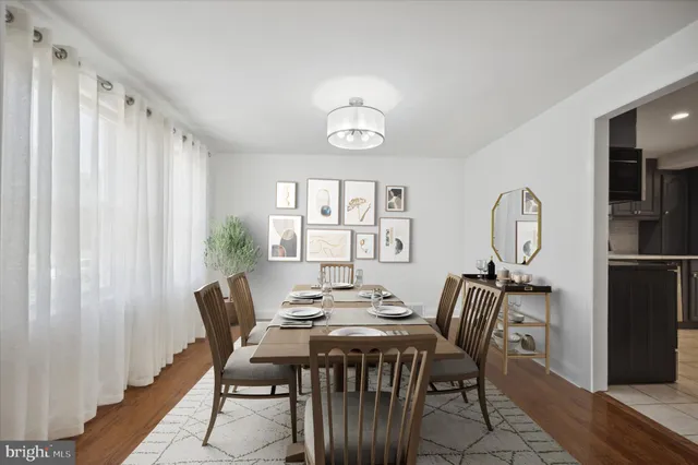 a view of a dining room with furniture window and wooden floor