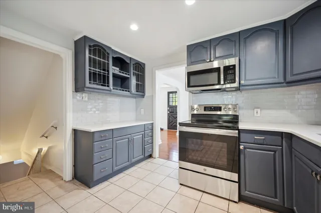 a kitchen with stainless steel appliances granite countertop a stove microwave and cabinets