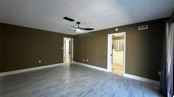 a view of an empty room with wooden floor
