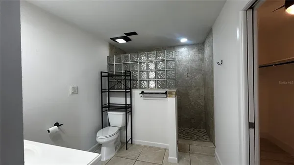 a bathroom with a toilet and a shower