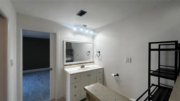 a bathroom with a sink a mirror and a shower