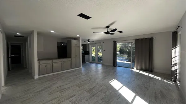 a view of interior space with wooden floor and windows