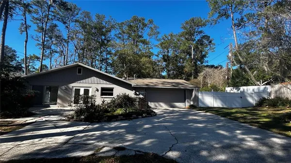 a view of a house with swimming pool and a yard