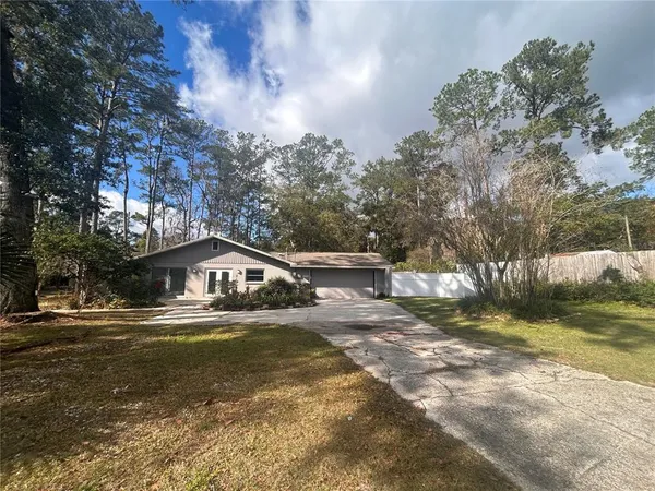 a view of a house with a tree in the background