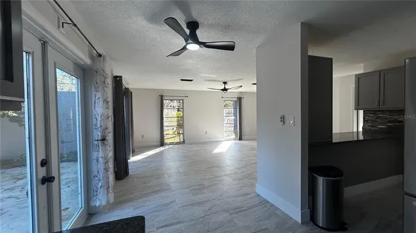 a view of a hallway with wooden floor and a cabinet