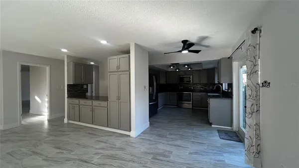 a view of a kitchen and refrigerator in a kitchen